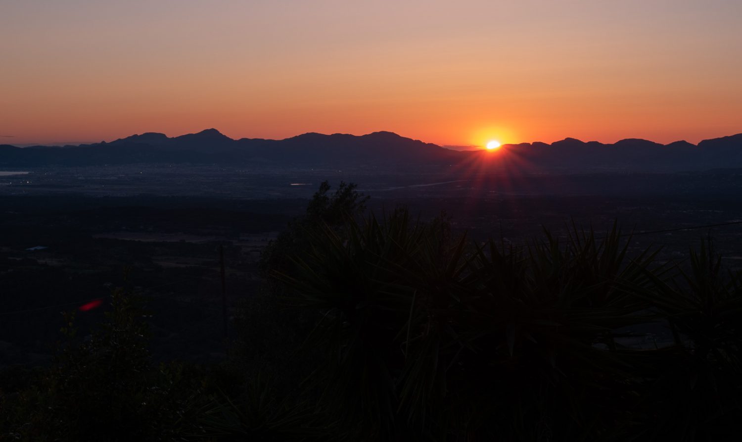 Shot of an orange sunset with foreground in complete darkness. 