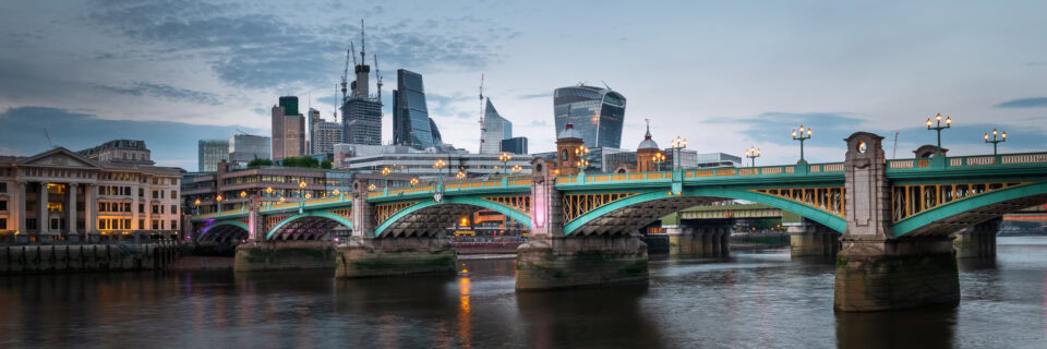 London skyline with Southwark Bridge over the River Thames at dusk.