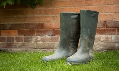 Pair of wellington boots on grass for waterfall photography, practical waterproof footwear.