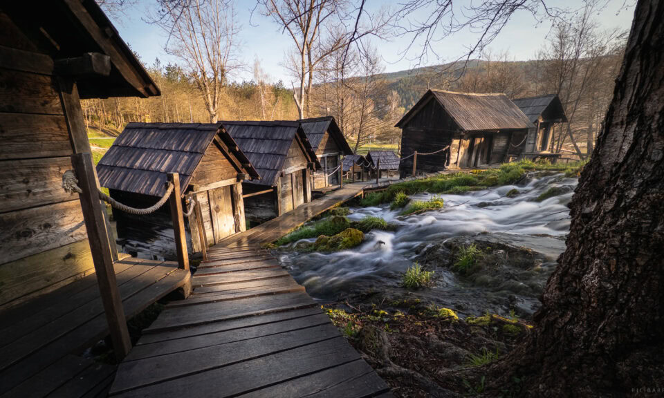Historic watermills along a flowing river in Mlinići Watermills, Bosnia and Herzegovina.