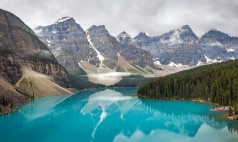 Moraine Lake with turquoise waters and surrounding mountain peaks in Banff National Park.
